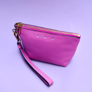 Purple wristlet cosmetic pouch wristlet with gold zipper on a purple background - MAGENTA