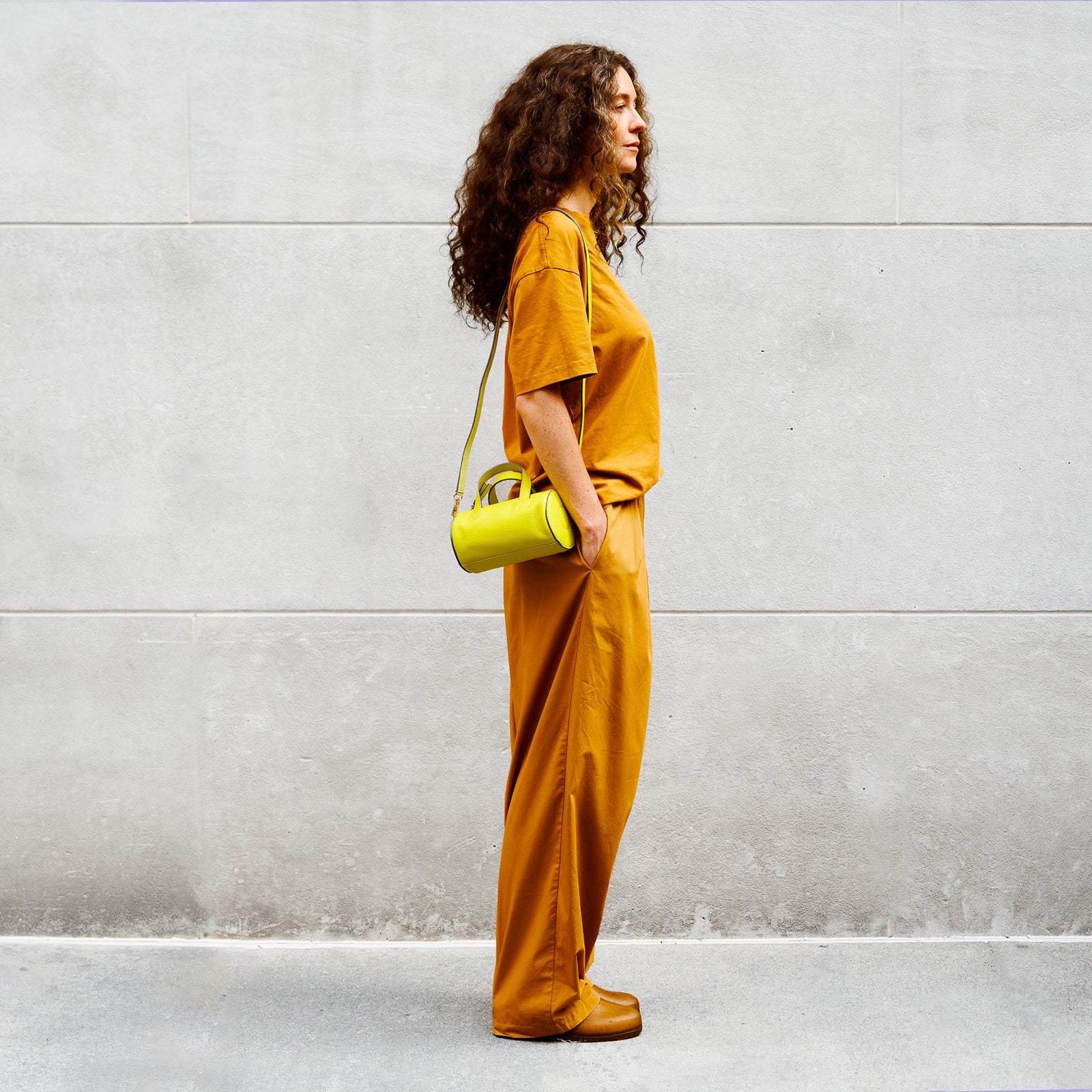 Sai Mini Barrel Bag in lime green Italian pebble grain leather, front view with top handles and crossbody strap - LIME