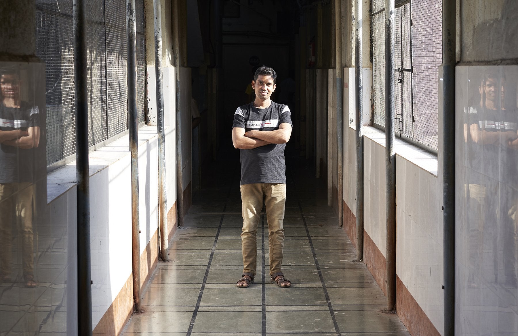 GOVIND stand in a sunlit corridor with reflective walls.