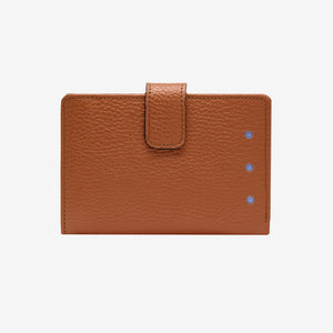 Brown leather wallet with a flap on a light gray background - TOAST