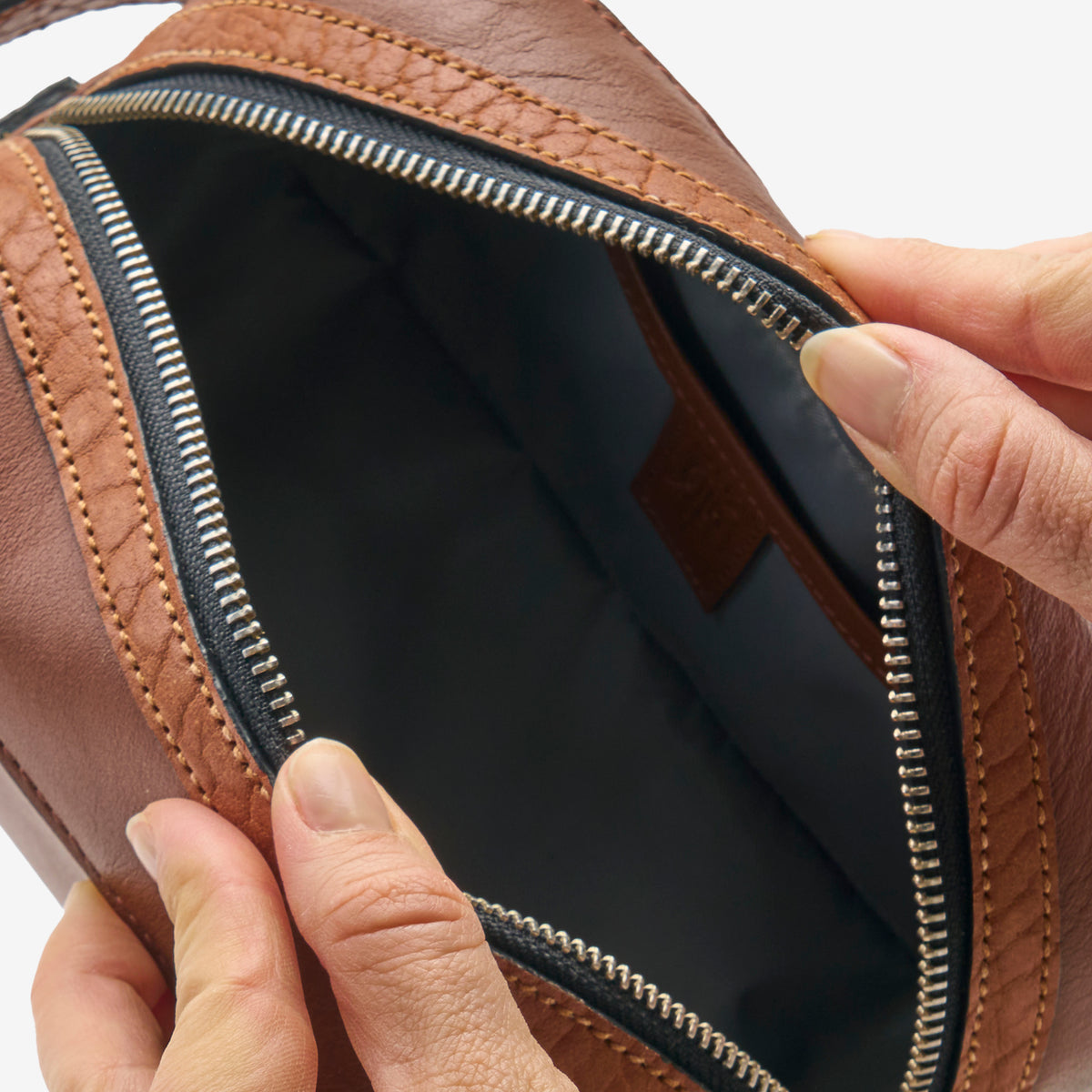 Tusk 770 Italian leather toiletry bag in Wood, open view — spacious interior with premium lining and zip compartments for organized packing  - WOOD