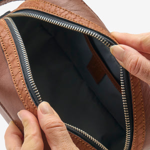 Tusk 770 Italian leather toiletry bag in Wood, open view — spacious interior with premium lining and zip compartments for organized packing  - WOOD