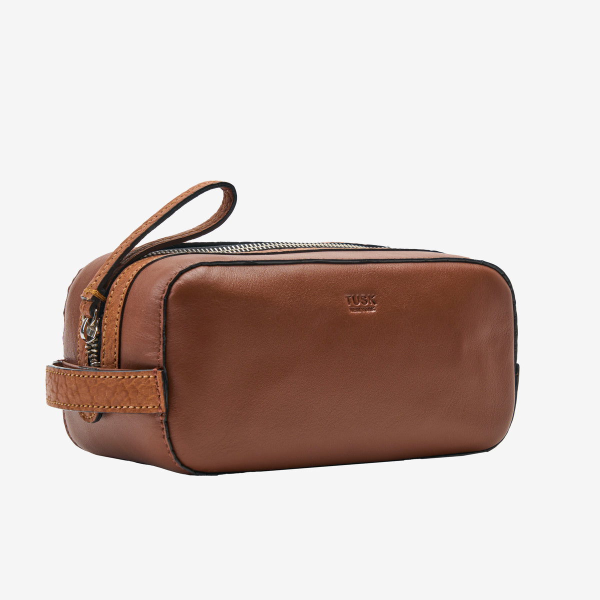 Tusk 770 Italian leather toiletry bag in Wood, side view — slim silhouette with wrist strap and zip closure for convenient travel use - WOOD