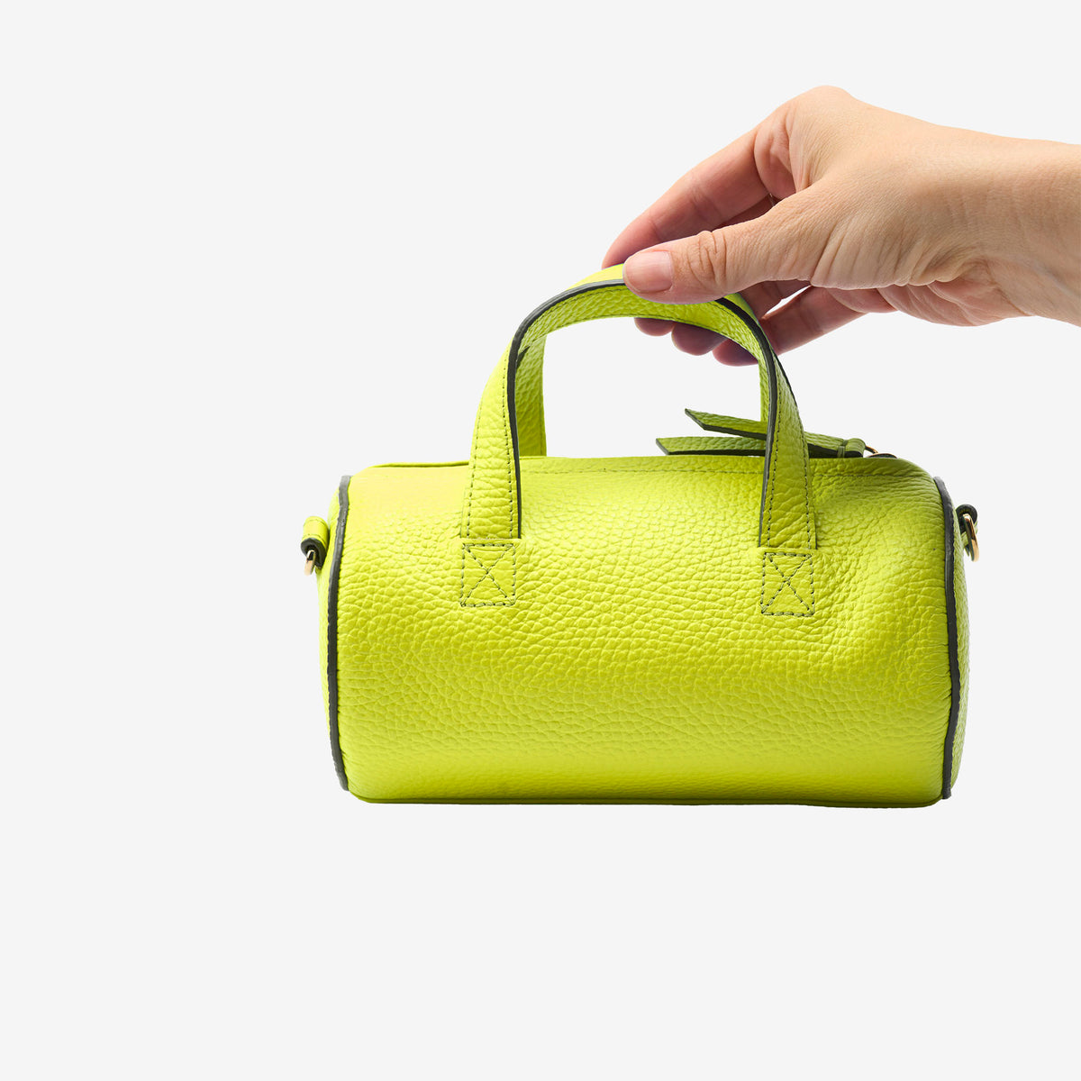 Sai Mini Barrel Bag in lime green italian pebble grain leather, held in hand to show size and soft textured finish - LIME