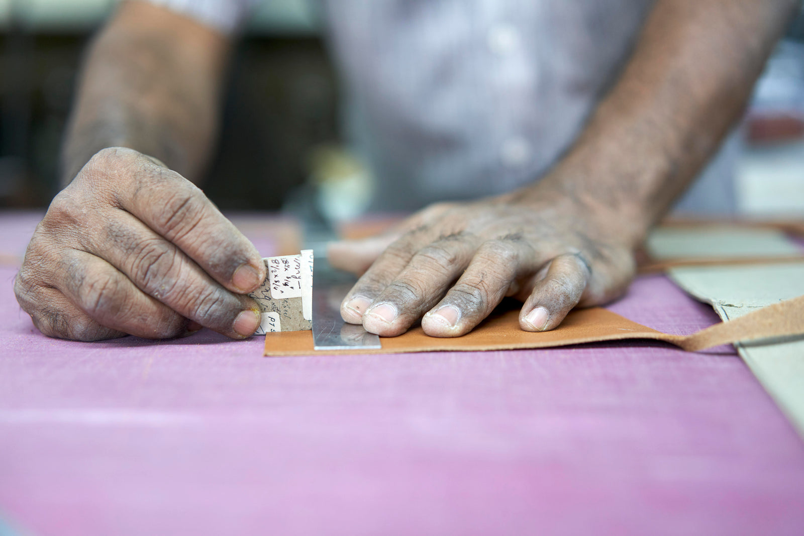 Close-up of hands holding a product, emphasizing craftsmanship and quality associated with Tusk's brand.