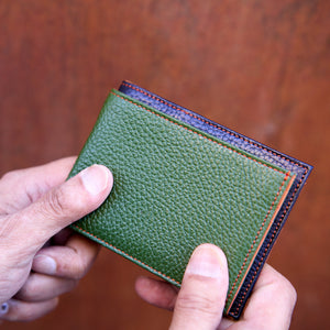 Man holding compact and regular size pebble grain billfold - FOREST