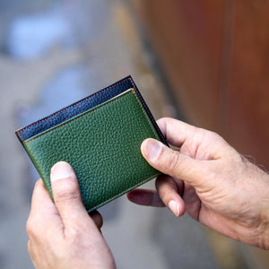 Man holding compact and regular size pebble grain billfold - FOREST