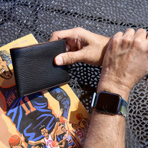 Man holding black pebble grain leather billfold - BLACK 