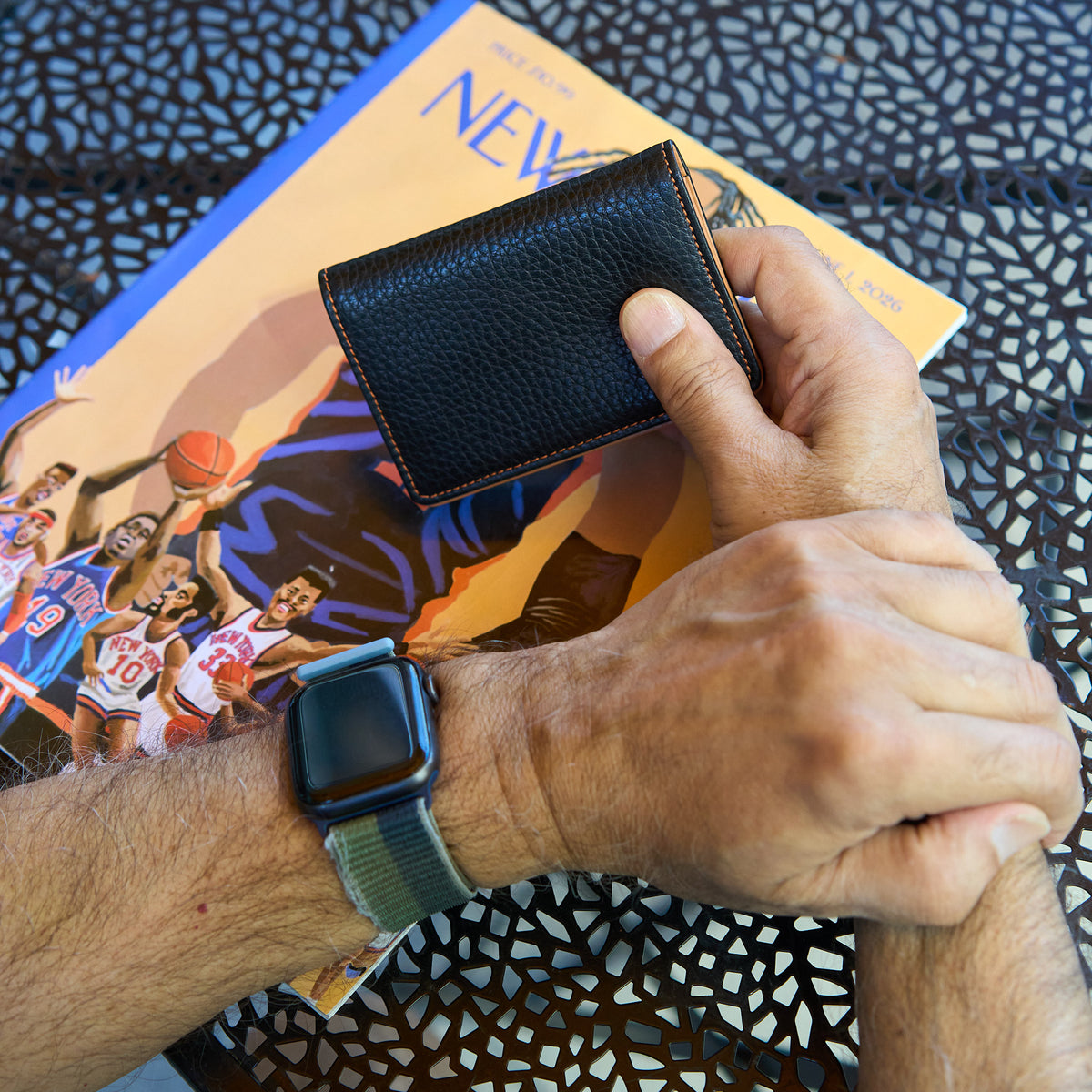 Man holding black pebble grain leather card case - BLACK