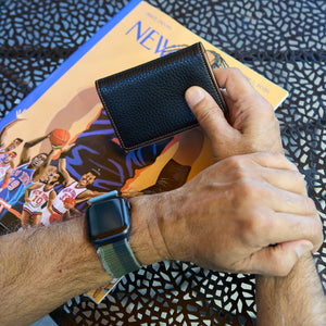 Man holding black pebble grain leather card case - BLACK