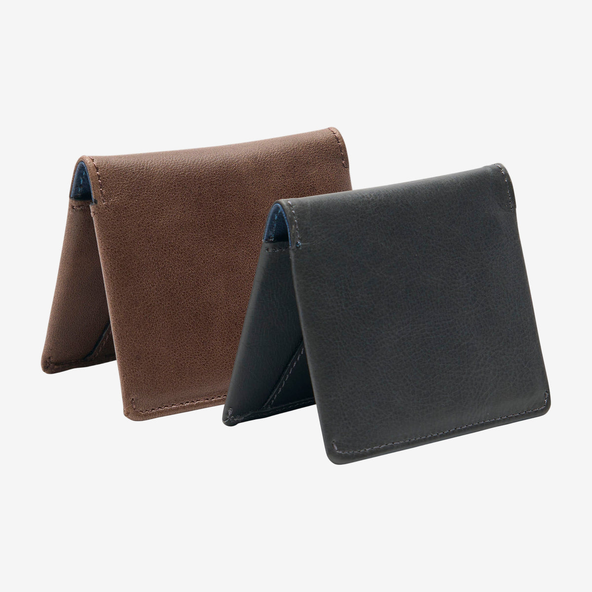 Two leather wallets, one brown and one black, on a white background - GREY