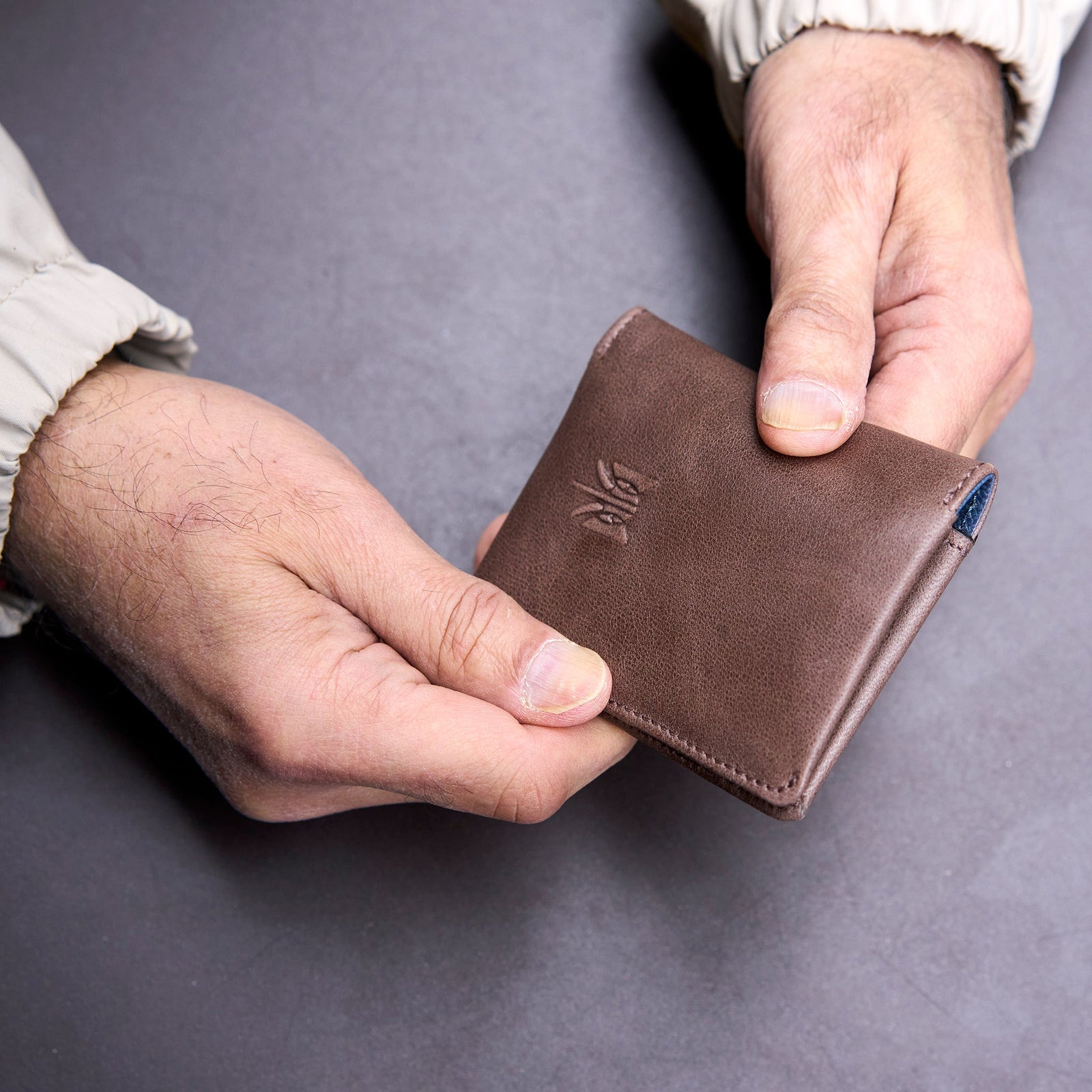 Brown leather wallet with a brand logo on a white background - BROWN