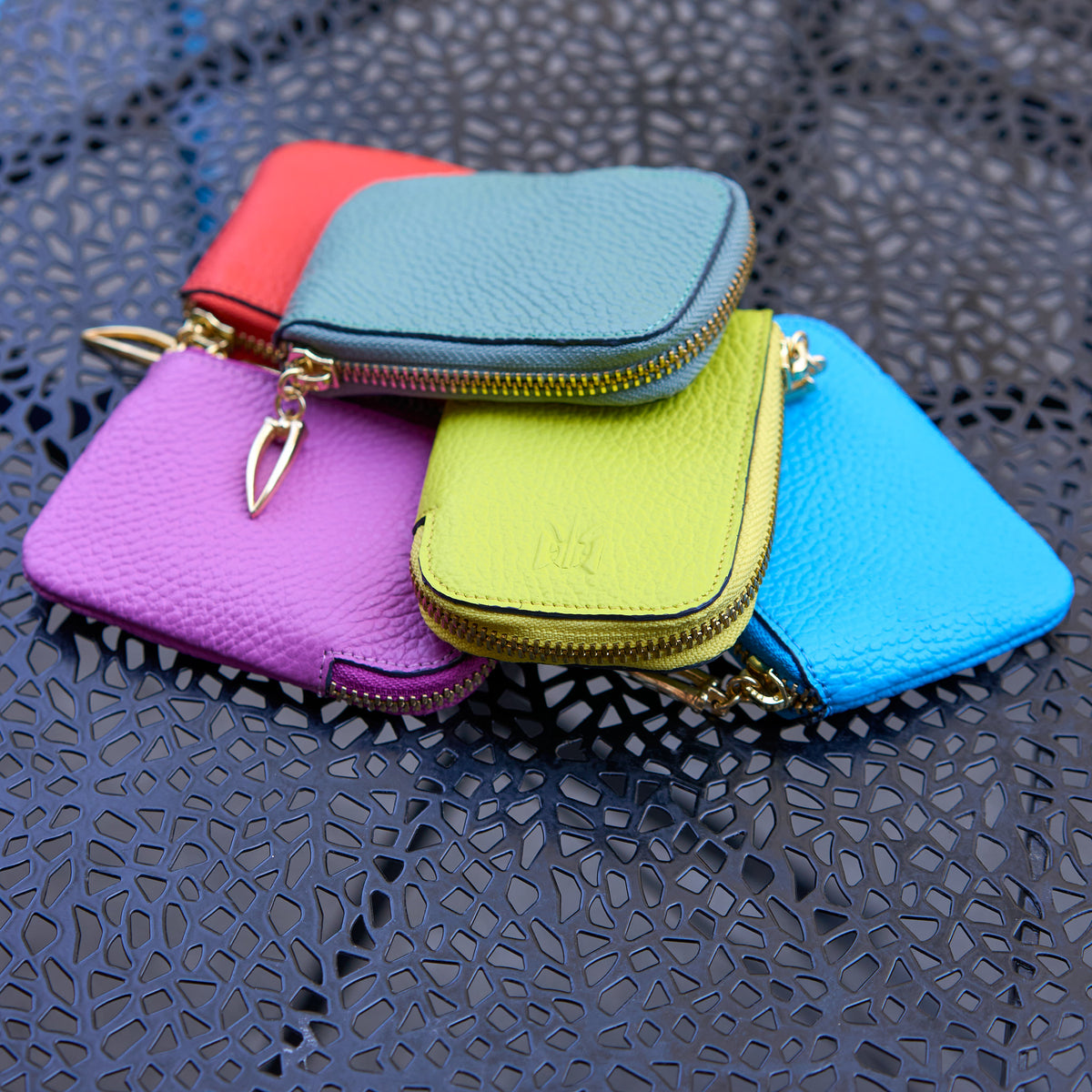 Tusk 194 Ascot small zip card wallets stacked on a cafe table -LIME