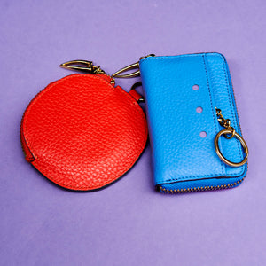 Blue leather wallet on a purple background with orange round coin purse - AZURE