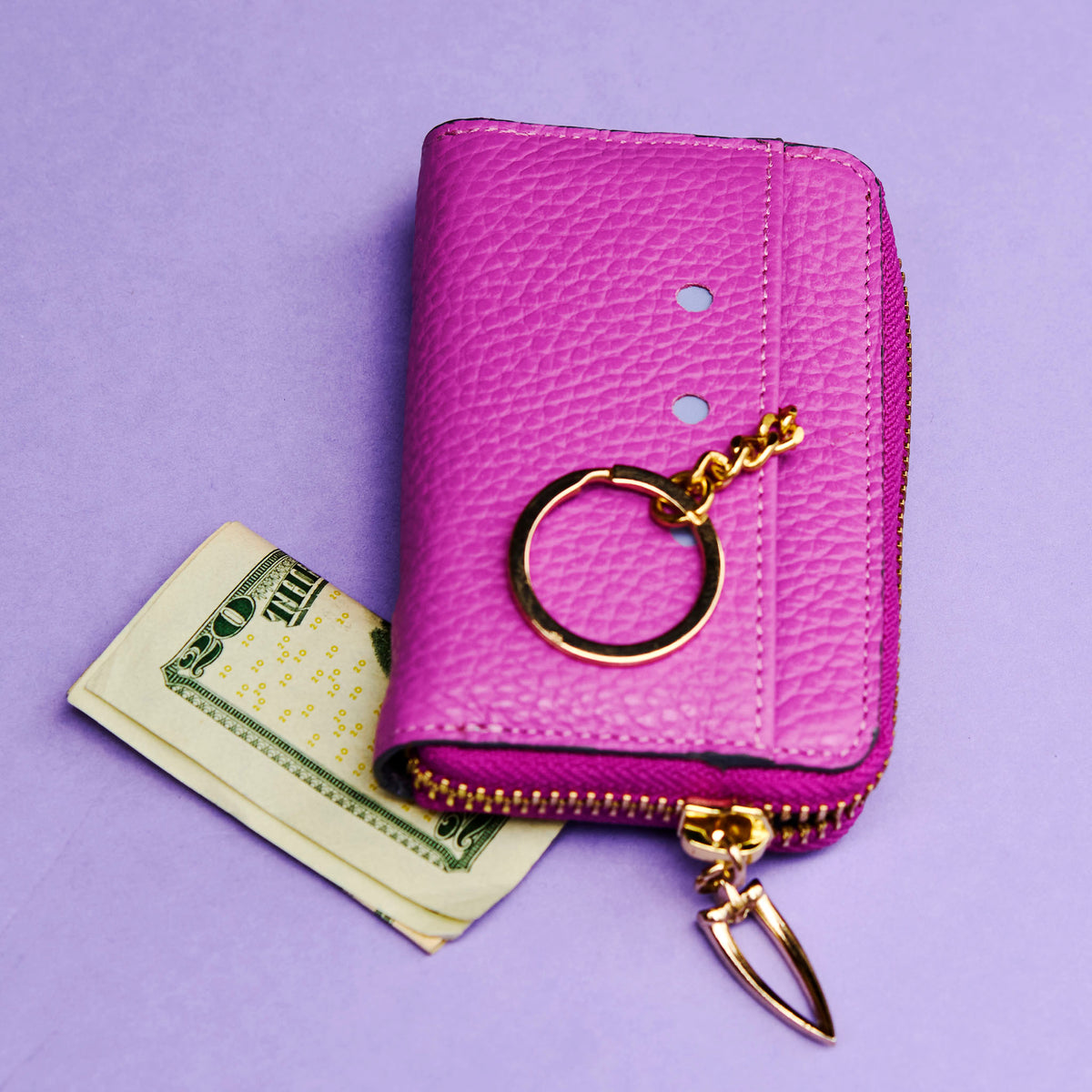 Magenta wallet with gold keychain on a purple background - MAGENTA