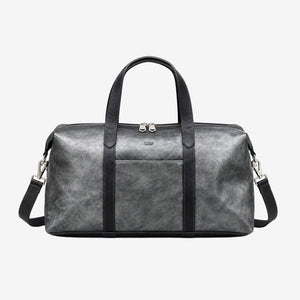 A gray distressed leather duffel bag with black handles, trim, and a detachable shoulder strap, featuring a front pocket and silver-tone hardware, shown against a plain white background - SILVER