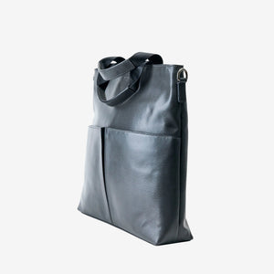 A dark gray leather tote bag with dual top handles and a front slip pocket, shown from a three-quarter angle on a white background - CHARCOAL