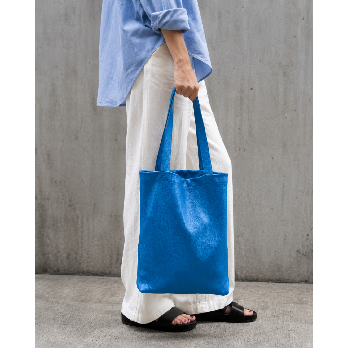 Blue italian leather tote bag on a light gray background - AZURE