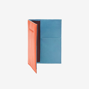 Orange  and blue passport holder with 'PASSPORT' text embossed on front on a white background - ORANGE/SKY