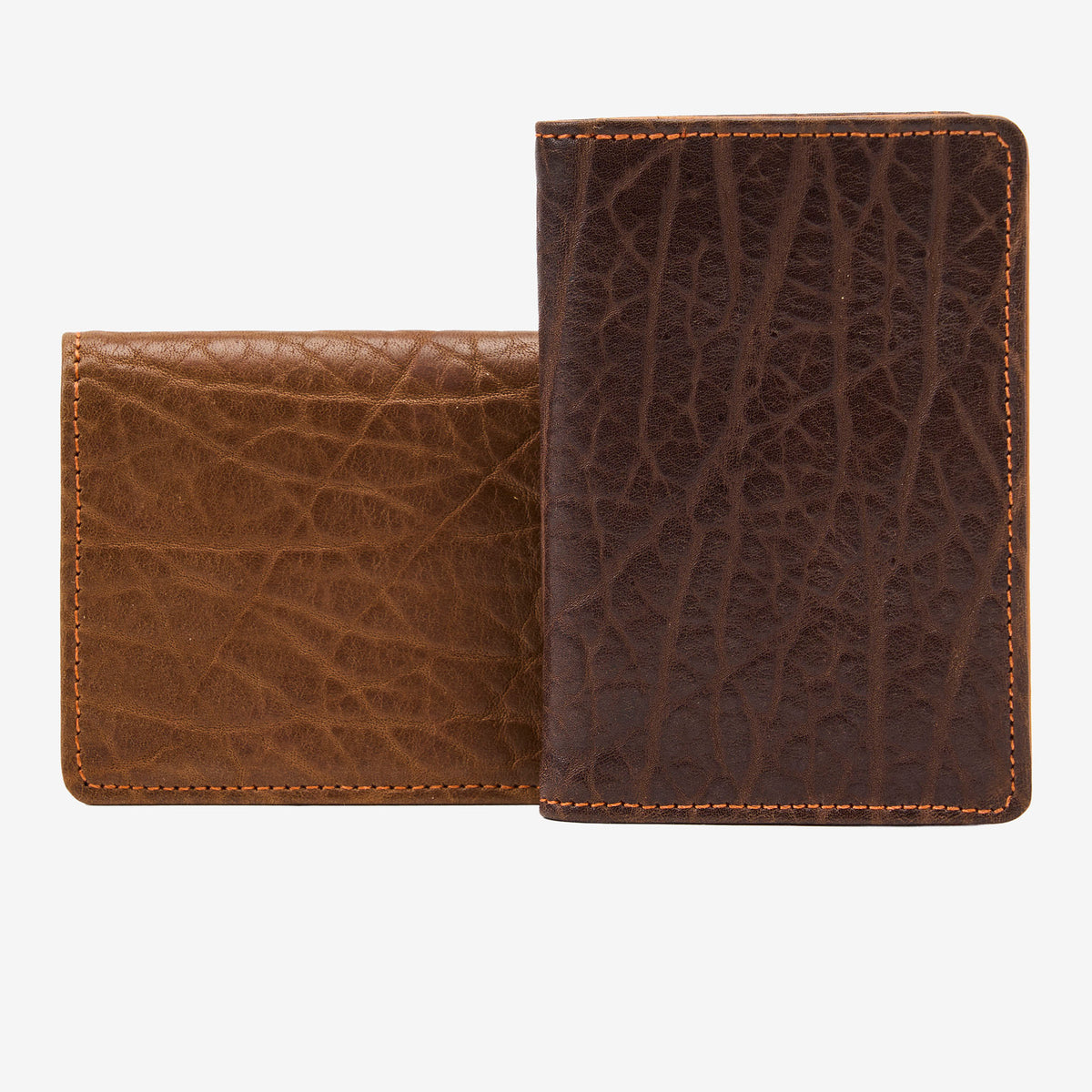 Two brown leather wallets with textured on a white background - TAN