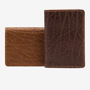 Two brown leather wallets with textured on a white background - TAN