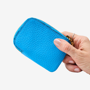 Tusk 194 Ascot small zip card wallet, held in hand - AZURE