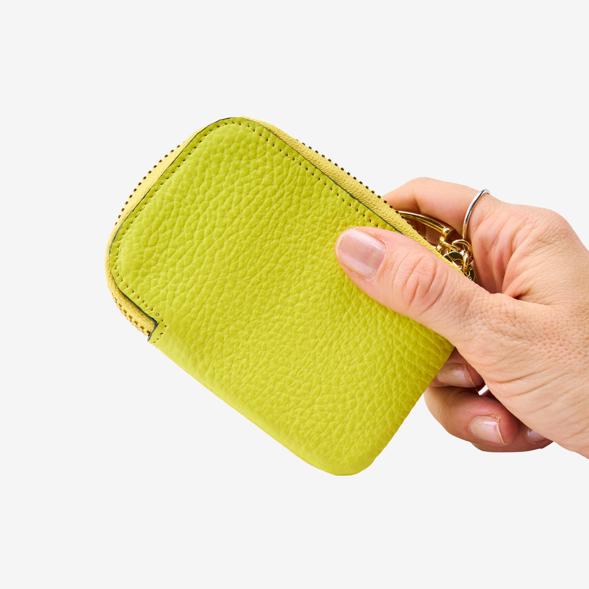 Tusk 194 Ascot small zip card wallet, held in hand - LIME