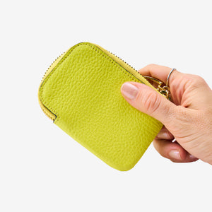Tusk 194 Ascot small zip card wallet, held in hand - LIME