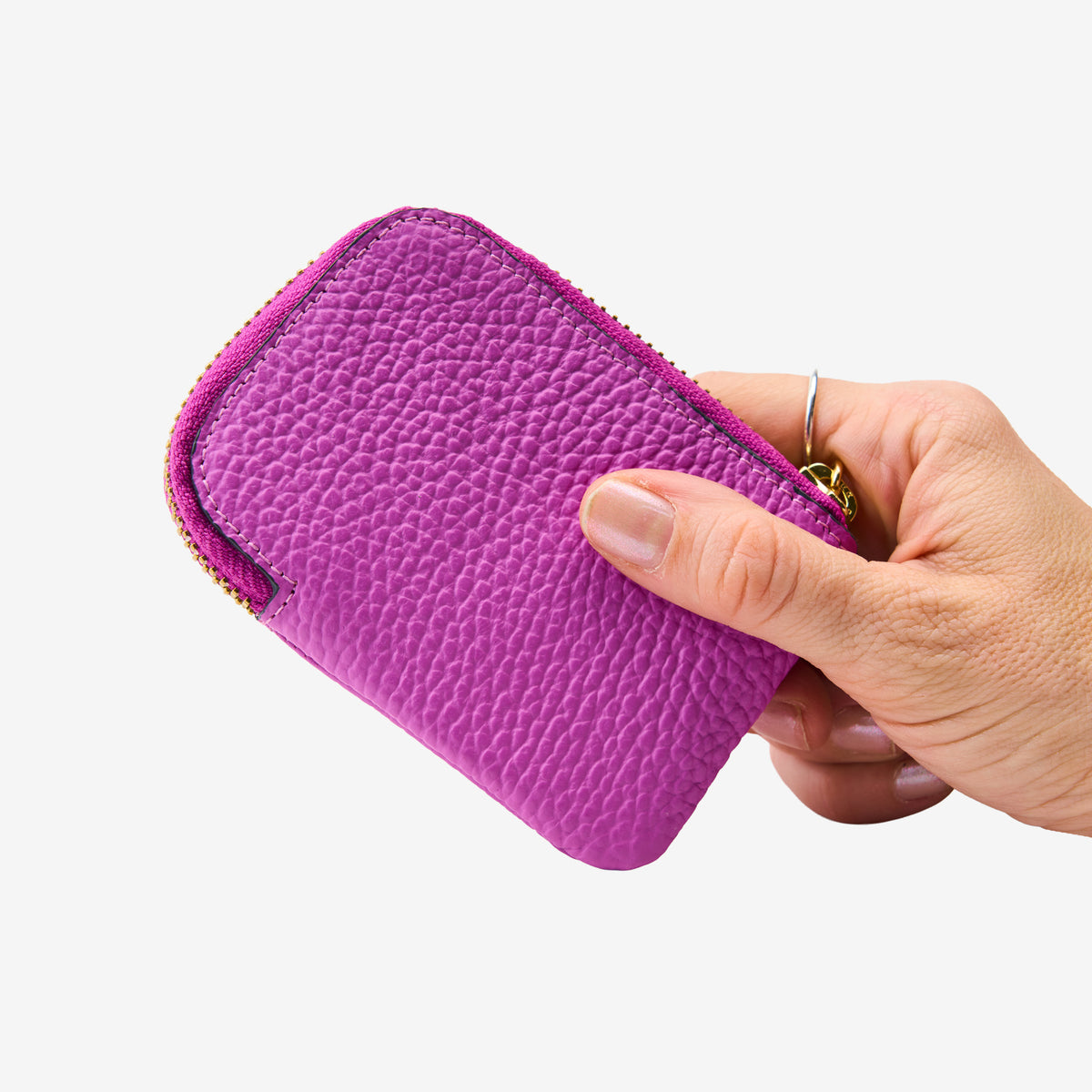 Tusk 194 Ascot small zip card wallet, held in hand - MAGENTA