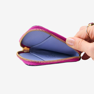 Tusk 194 Ascot small zip card wallet, open and held in hand - MAGENTA