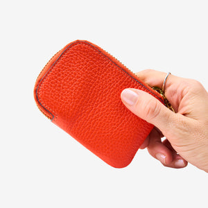 Tusk 194 Ascot small zip card wallet, held in hand - ORANGE