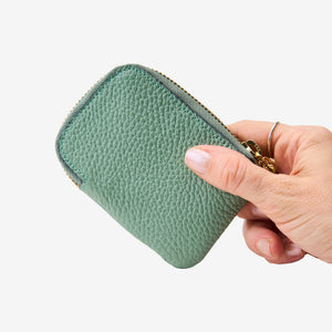 Tusk 194 Ascot small zip card wallet, held in hand - SAGE