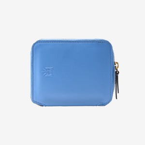 A light blue leather zip-around wallet with a debossed logo on the front and a gold-tone zipper pull, shown against a plain white background - FRENCH BLUE