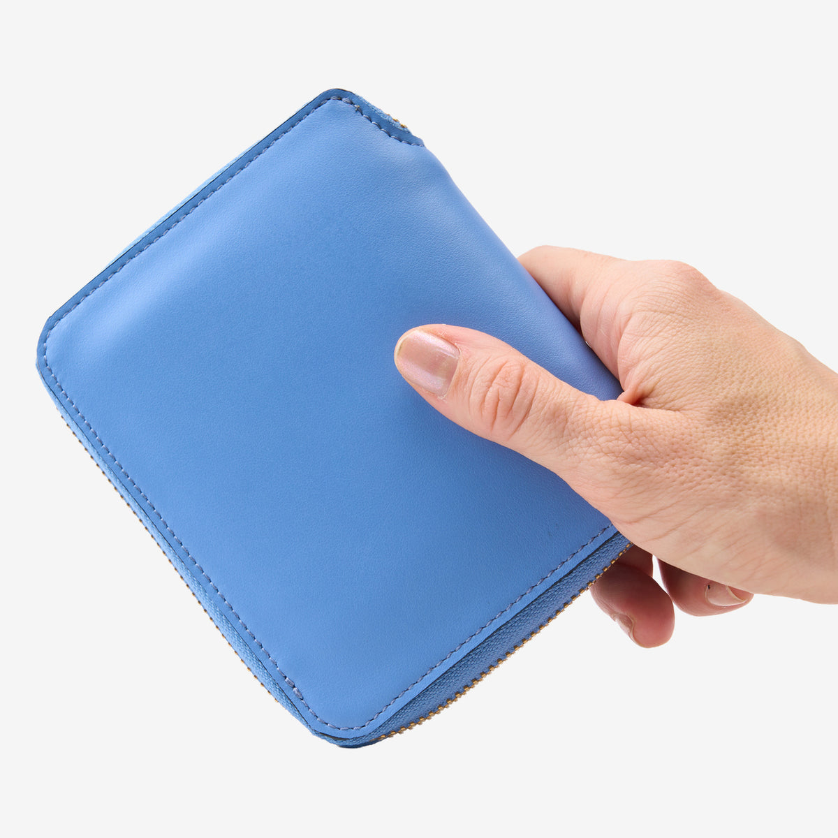 Tusk Lille medium leather zip-around wallet, shown in hand - FRENCH BLUE