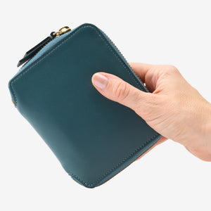 Tusk Lille medium leather zip-around wallet, shown in hand - HUNTER