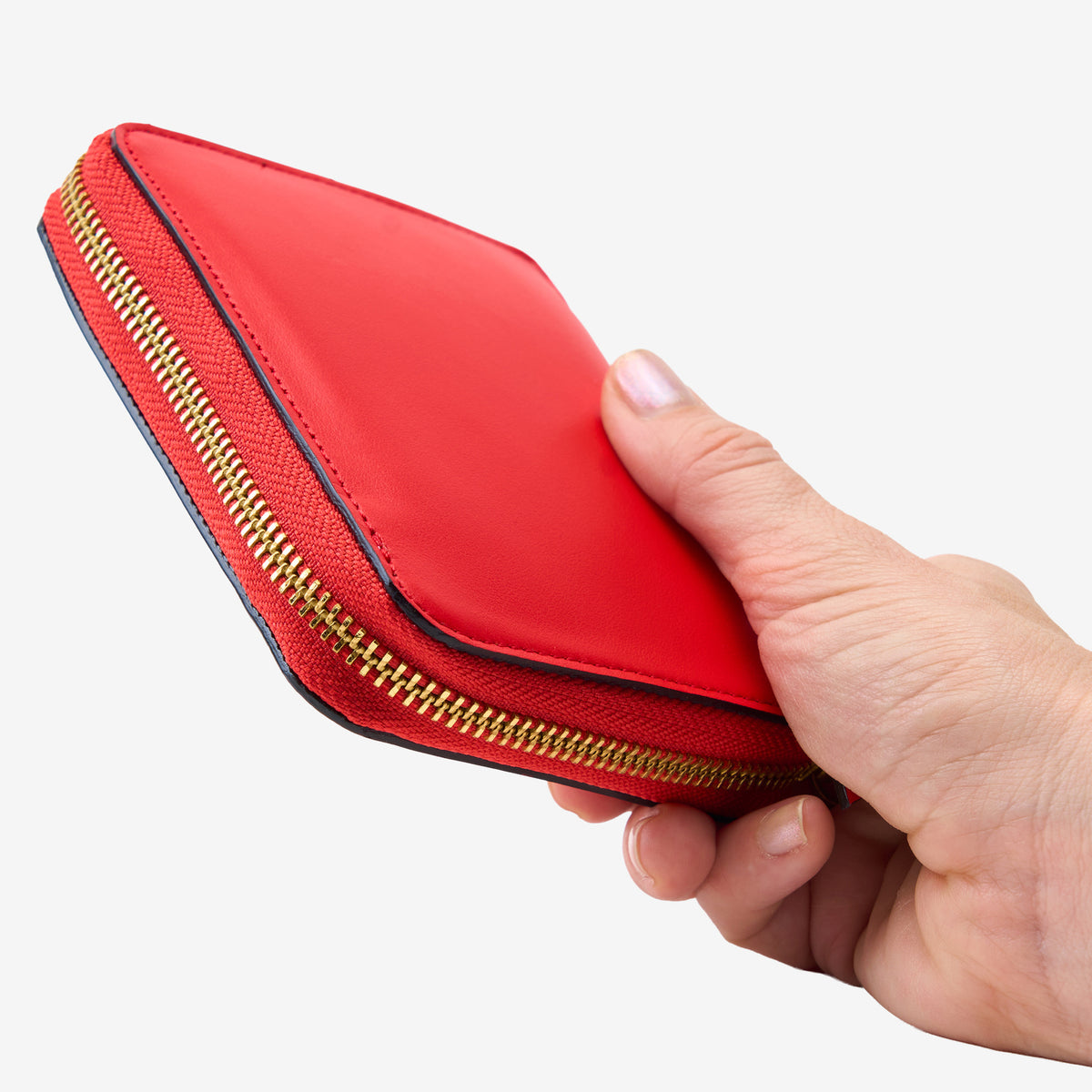 Tusk Lille medium leather zip-around wallet, shown in hand - RED