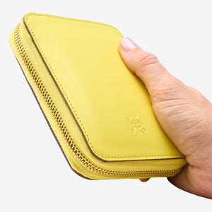 Tusk Lille medium leather zip-around wallet, shown in hand - SUN