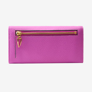 Back view of the Ascot flap-over wallet in magenta pebbled leather, displaying the exterior zipper compartment with a gold-tone zipper and a distinct triangular pull tab against a light gray background - MAGENTA