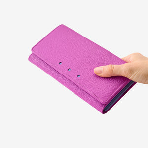 Tusk Ascot Flap Over Leather Wallet in Magenta held in hand, displaying the premium pebble-grain Italian leather and elegant fold-over design - MAGENTA
