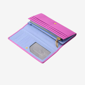 Interior view of the open Ascot flap-over wallet in magenta pebbled leather, displaying its contrast leather interior lining, twelve card slots, a clear ID window, and a gold-tone zipper compartment with a signature pull tab against a light gray background - MAGENTA