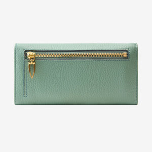 Back view of the Ascot flap-over wallet in sage green pebbled leather, displaying the exterior zipper compartment with a gold-tone zipper and a distinct triangular pull tab against a light gray background - SAGE
