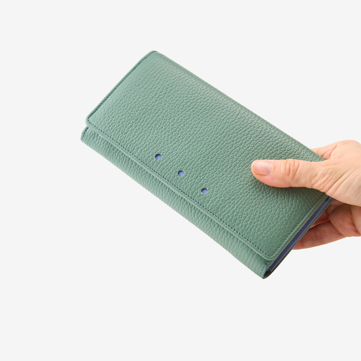 Tusk Ascot Flap Over Leather Wallet in Sage Green held in hand, displaying the premium pebble-grain Italian leather and elegant fold-over design - SAGE