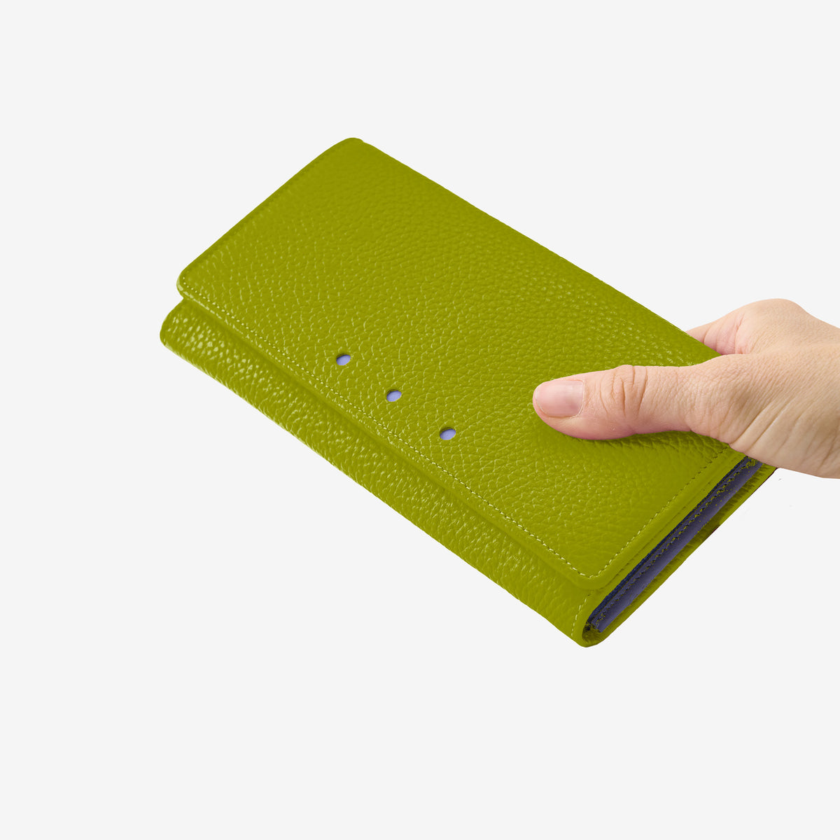 Tusk 376 Ascot Flap Over Wallet in avocado Italian pebble-grain cowhide leather. In-hand view showing the wallet's scale and leather texture - AVOCADO