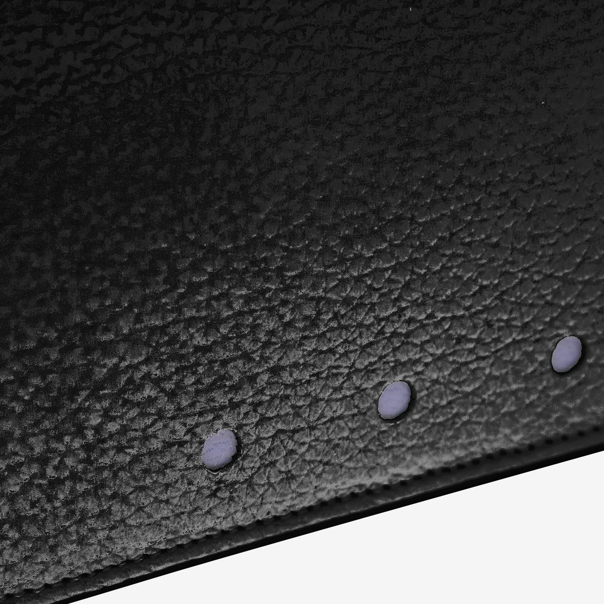 Tusk 376 Ascot Flap Over Wallet in black Italian pebble-grain cowhide leather. Close-up of the photographed pebble-grain leather and matching stitching - BLACK