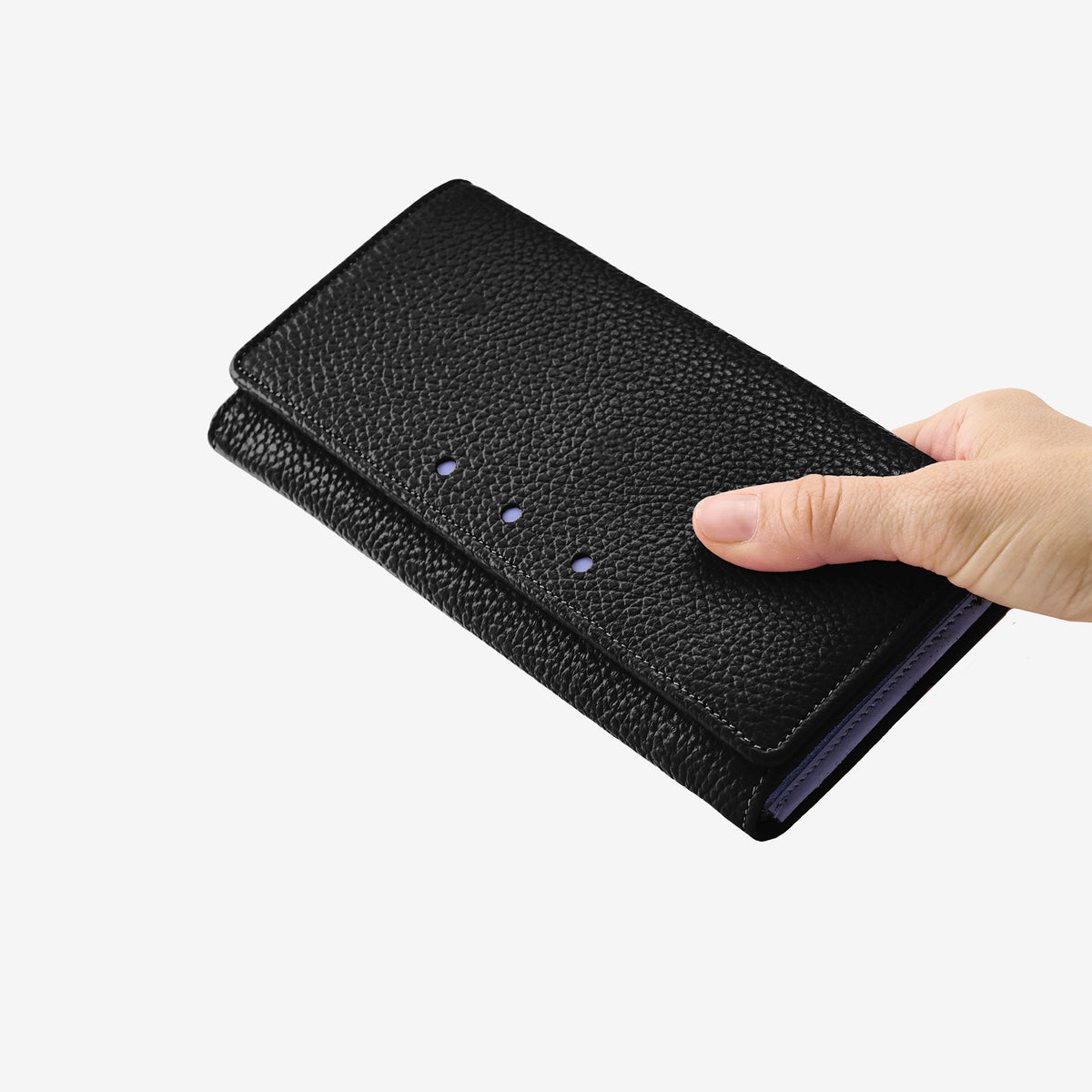 Tusk 376 Ascot Flap Over Wallet in black Italian pebble-grain cowhide leather. In-hand view showing the wallet's scale and leather texture - BLACK