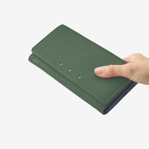 Tusk 376 Ascot Flap Over Wallet in forest Italian pebble-grain cowhide leather. In-hand view showing the wallet's scale and leather texture - FOREST