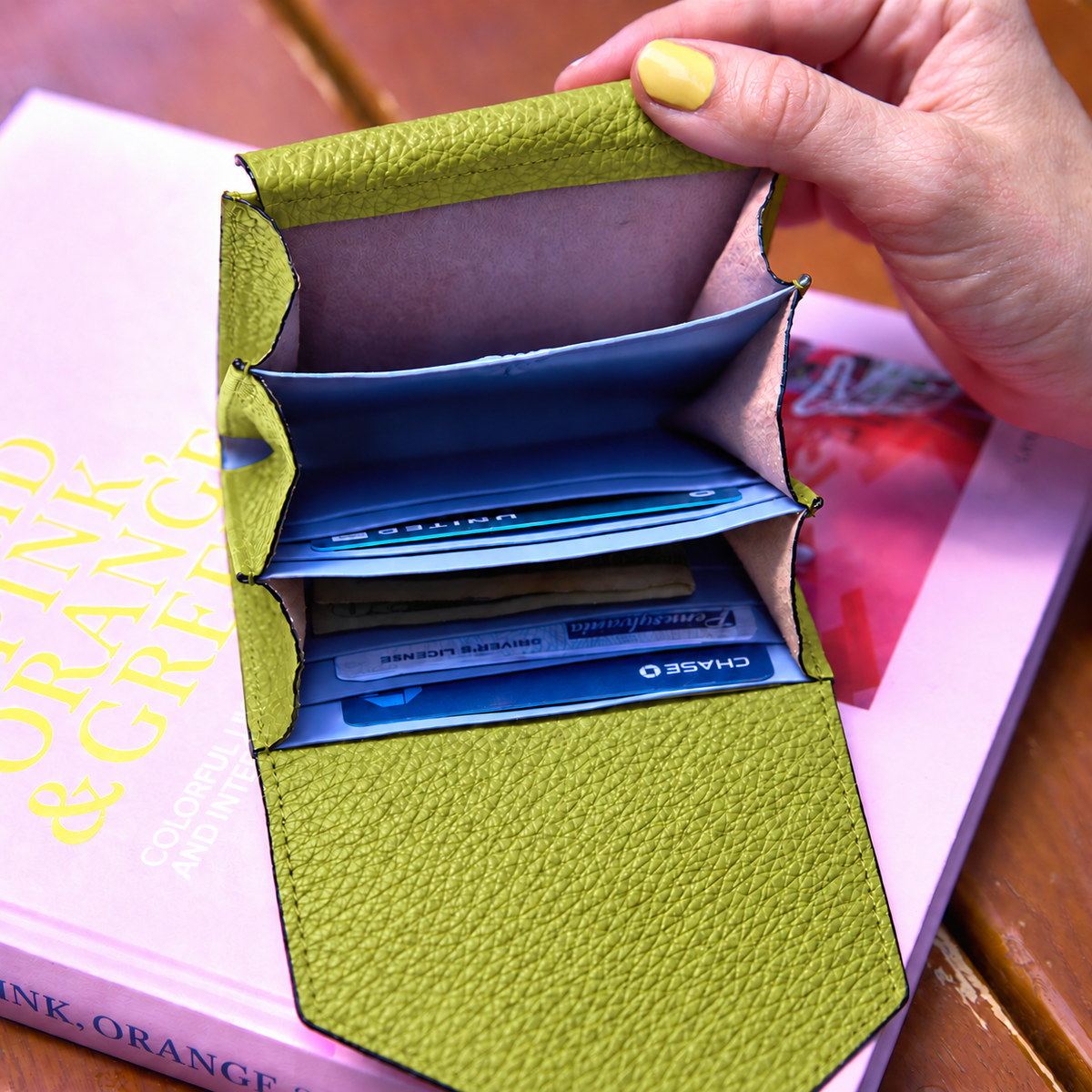 Tusk 382 Ascot Origami Wallet in avocado Italian pebble-grain cowhide leather. Wallet held open with a matching pebble-grain leather flap and original lavender-blue dividers - AVOCADO