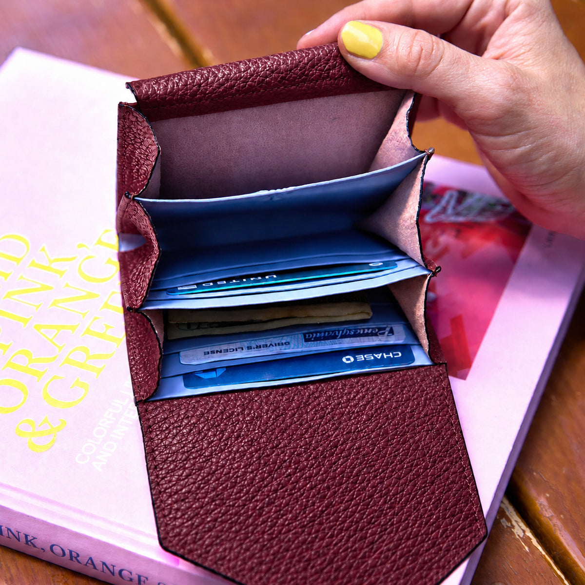 Tusk 382 Ascot Origami Wallet in oxblood Italian pebble-grain cowhide leather. Wallet held open with a matching pebble-grain leather flap and original lavender-blue dividers - OXBLOOD