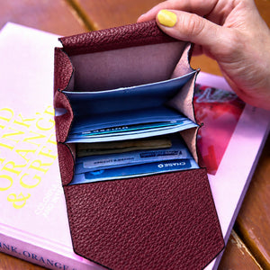 Tusk 382 Ascot Origami Wallet in oxblood Italian pebble-grain cowhide leather. Wallet held open with a matching pebble-grain leather flap and original lavender-blue dividers - OXBLOOD