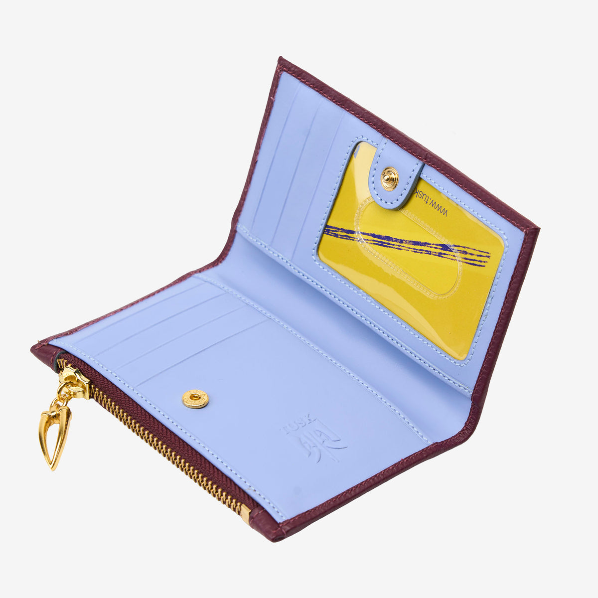 Open wallet with purple interior and gold zipper, featuring a yellow card holder on a white background - OXBLOOD